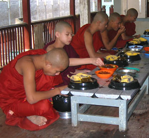 Young monks eating at monastery in Myanmar (Burma)